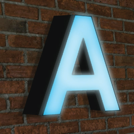 Front lit LED channel letter glowing on a brick wall